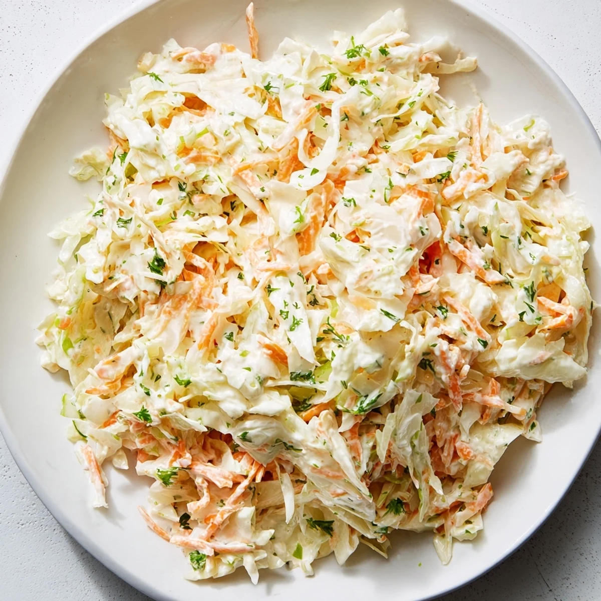 This refreshing coleslaw with apple features shredded cabbage, carrots, and a tangy, vibrant dressing for lunch.