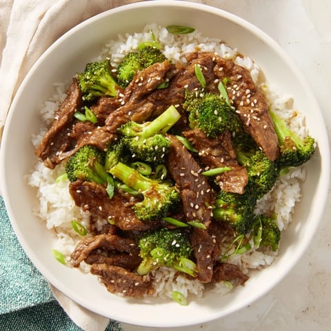 Tender beef and broccoli stir-fry glistening with savory sauce, ready for serving over rice.