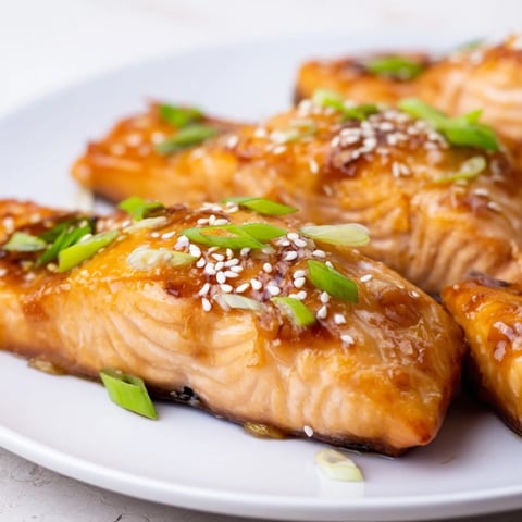 Golden, glazed Honey Garlic Salmon fillets, glistening with a savory sauce, ready to be enjoyed.