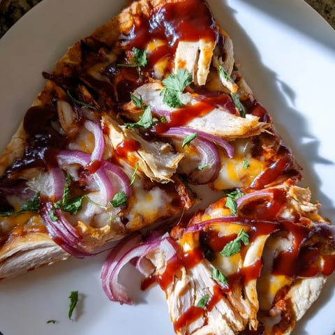 Golden, bubbly Chicken BBQ Pizza featuring smoky grilled chicken and melted cheese, ready to eat.