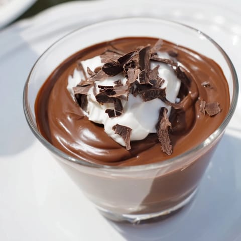Rich, dark chocolate pudding swirled in a glass, a decadent dessert for any occasion.
