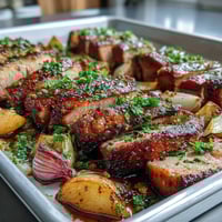Freshly roasted Pork and Aromatic Rhubarb Traybake with caramelized red onions and tender ginger-spiced pork slices.